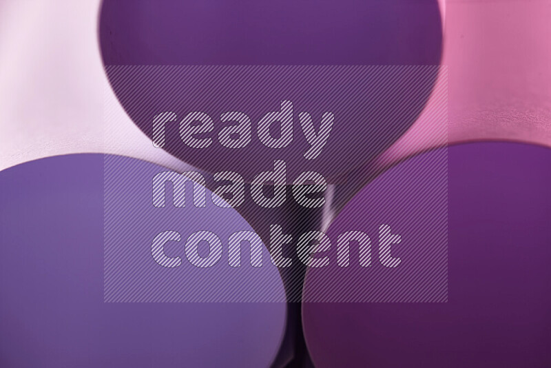 The image shows an abstract paper art with circular shapes in varying shades of purple