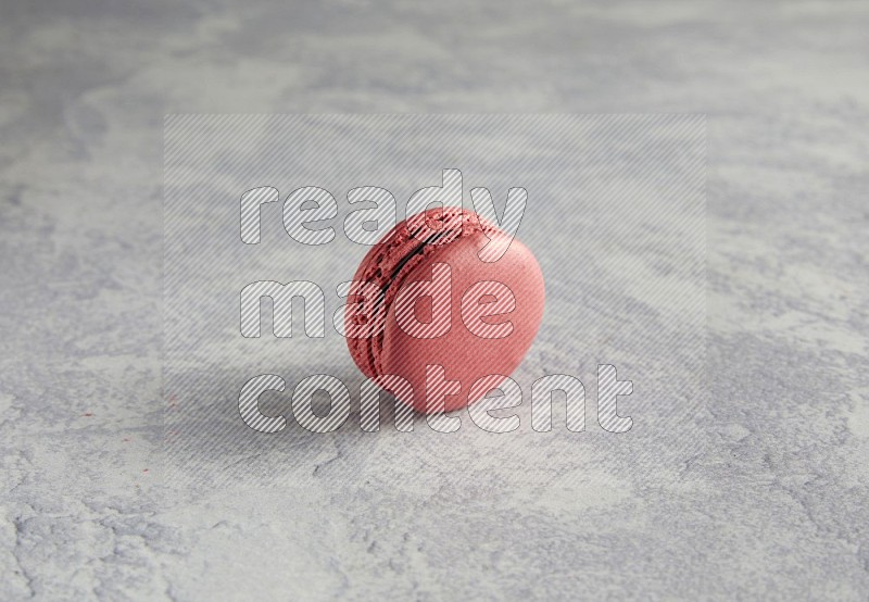 45º Shot of Pink Raspberry macaron on white  marble background