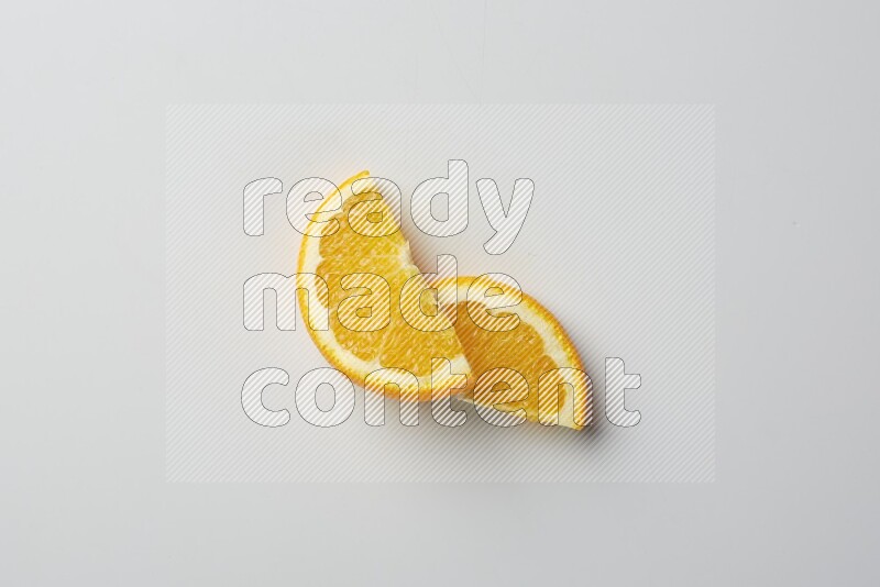 Two halves of an orange slices on white background