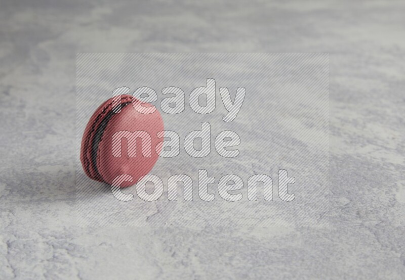 45º Shot of Red Cherry macaron on white  marble background