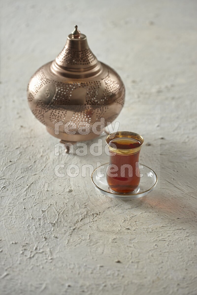A golden lantern with different drinks, dates, nuts, prayer beads and quran on textured white background