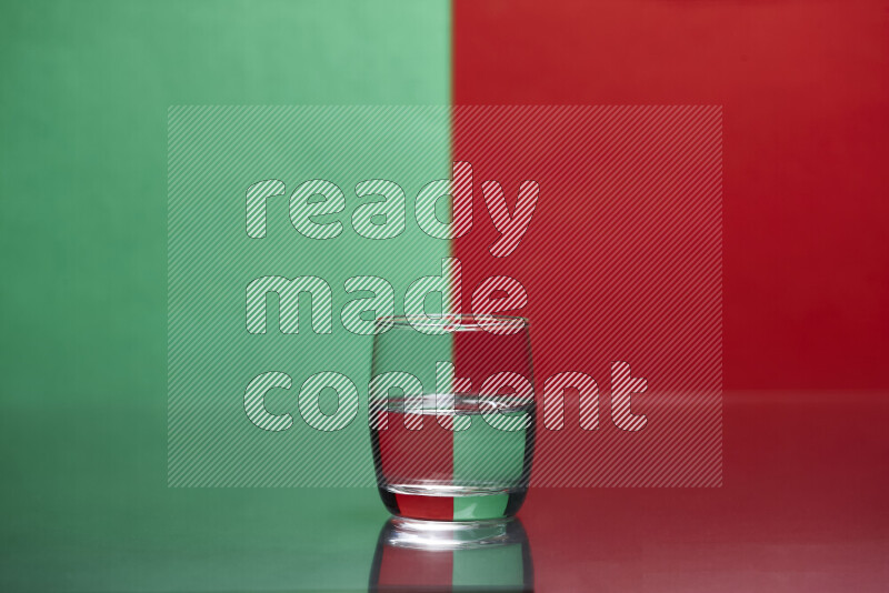 The image features a clear glassware filled with water, set against green and red background
