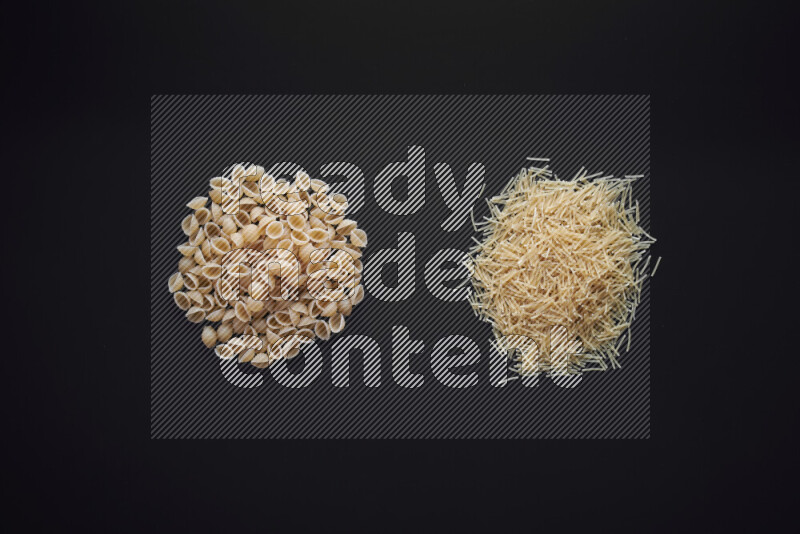 Different pasta types in bunches on black background