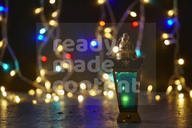A traditional ramadan lantern surrounded by glowing fairy lights in a dark setup