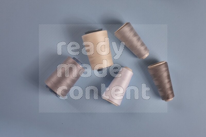 A grey collection of sewing and tailoring tools arranged on a blue background