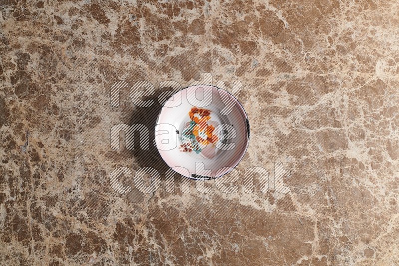 Top View Shot Of A Vintage Metal Plate On beige Marble Flooring