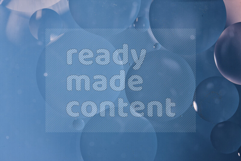 لقطات مقربة لفقاعات من الزيت على سطح الماء باللون الأزرق