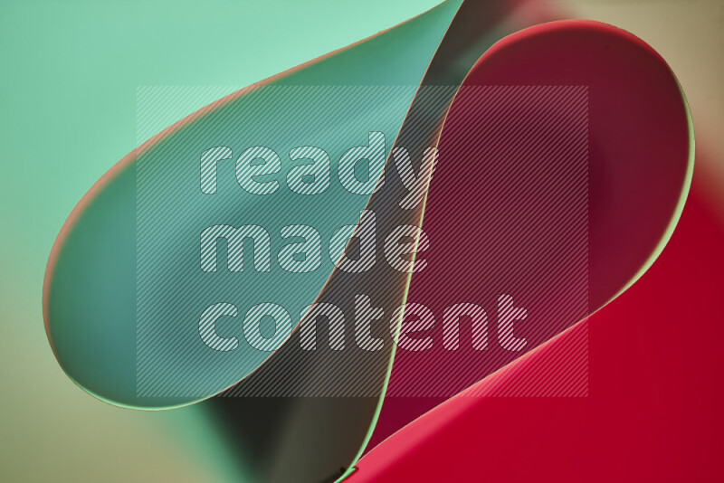 An abstract art of paper folded into smooth curves in green and red gradients