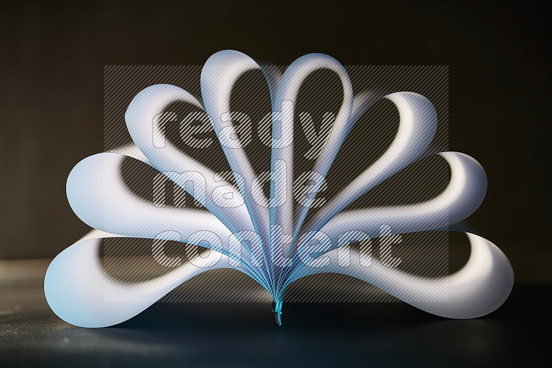 An abstract art piece displaying smooth curves in blue and white gradients created by colored light