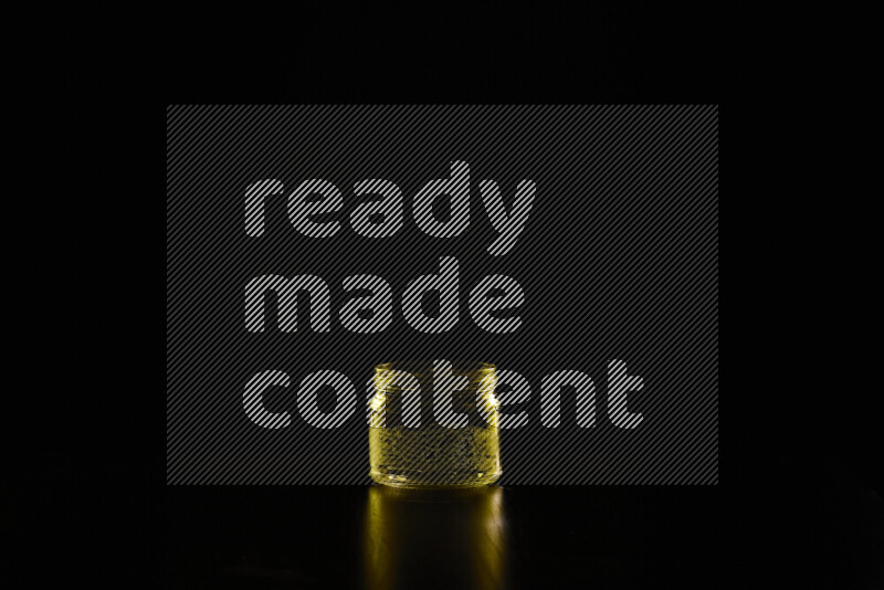 Glassware with rim light in yellow against black background