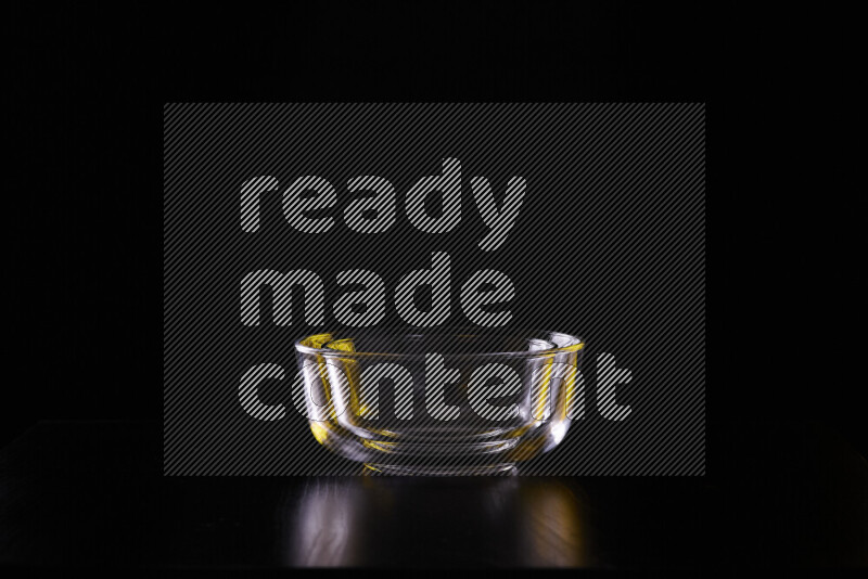 Glassware with rim light in yellow and white against black background