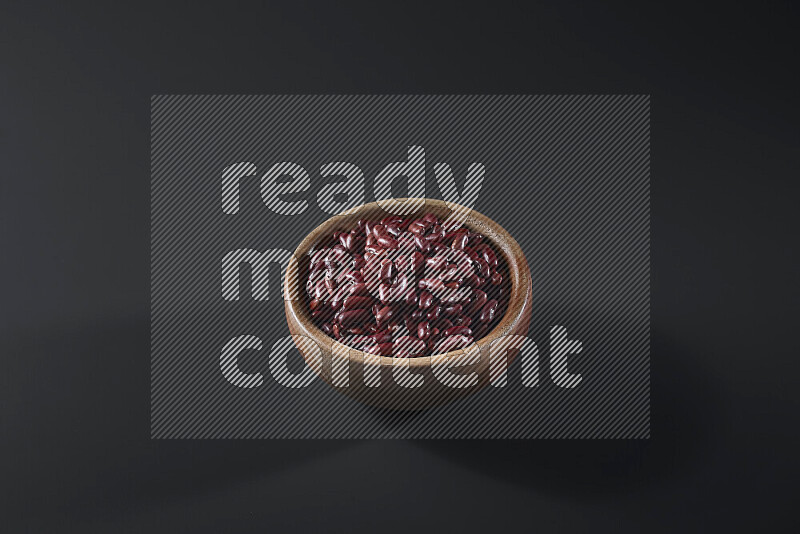 Red kidney beans in a wooden bowl on grey background