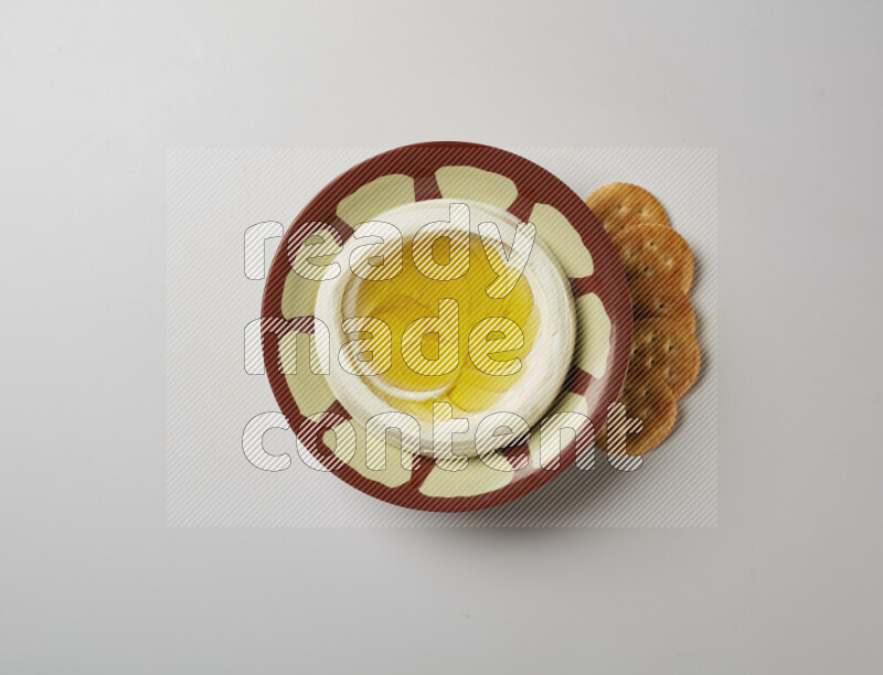 Lebnah garnished with olive oil in a traditional plate on a white background
