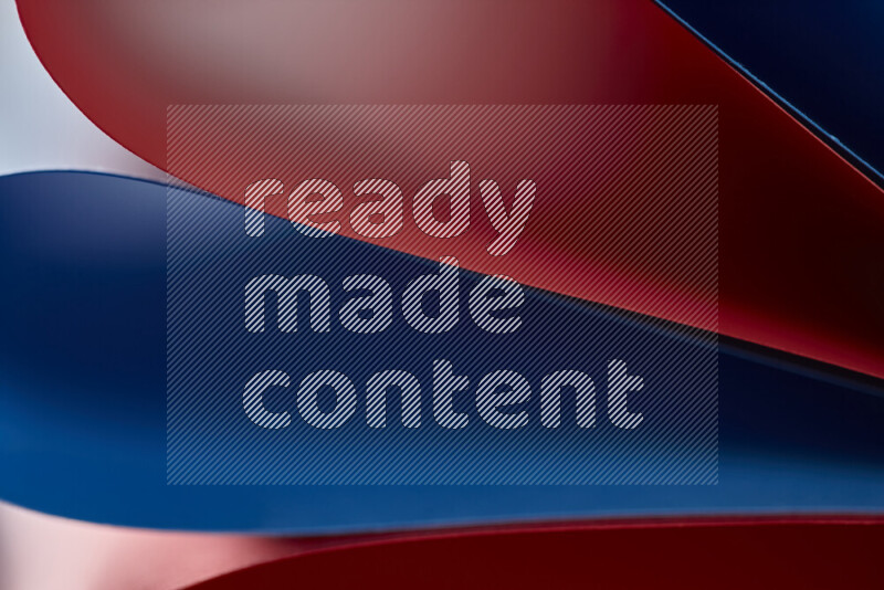 An abstract art showing red and blue paper sheets arranged in an overlapping curves