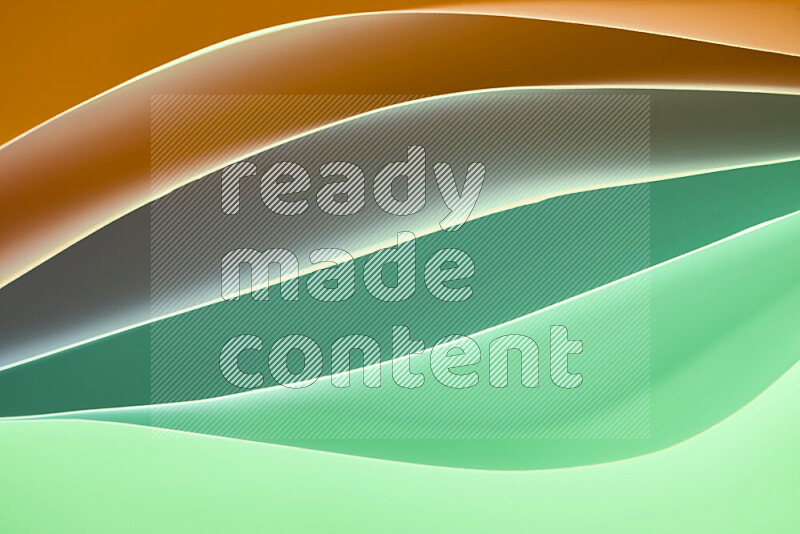This image showcases an abstract paper art composition with paper curves in green and orange gradients created by colored light