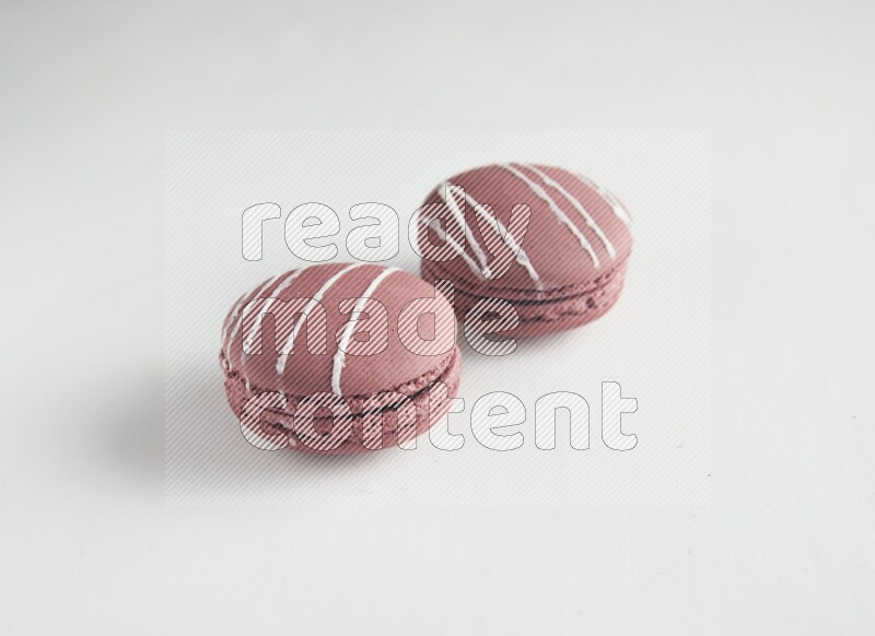 45º Shot of two Red Poppy Flower macarons on white background