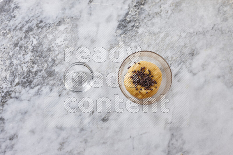 Cookies step by step with its ingredient, flour, butter, brown sugar, egg, vanilla extract, white sugar, chocolate chips and baking soda on grey marble background