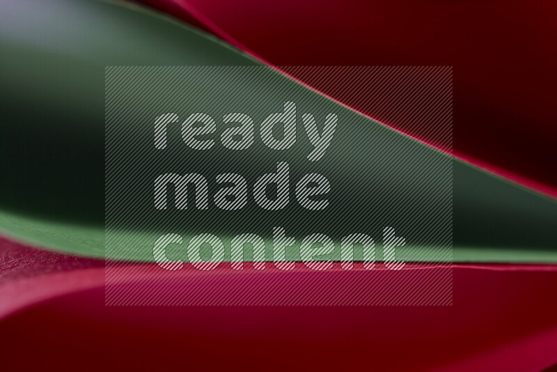 An abstract art showing red and green paper sheets arranged in an overlapping curves