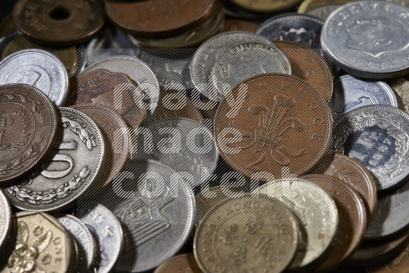 A close-ups of random old coins on black background
