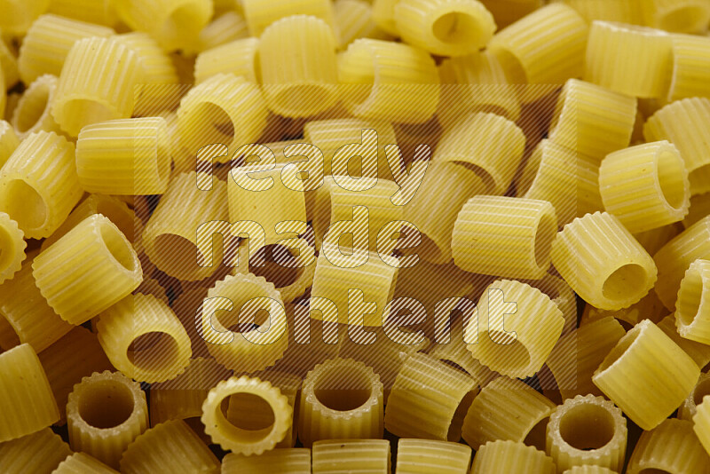 Big rings pasta on grey background