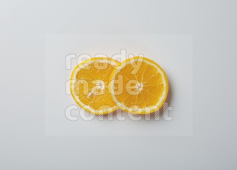 Two orange slices on white background