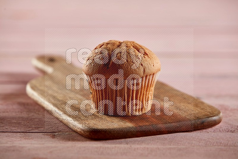 Vanilla cupcake on a wooden board