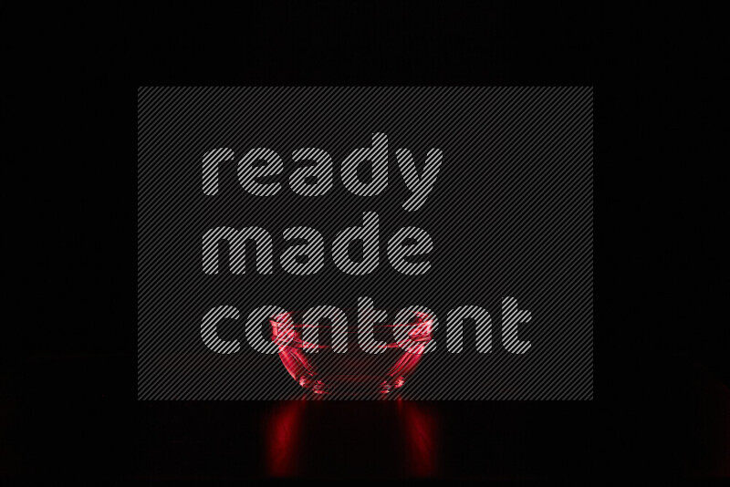 Glassware with rim light in red against black background