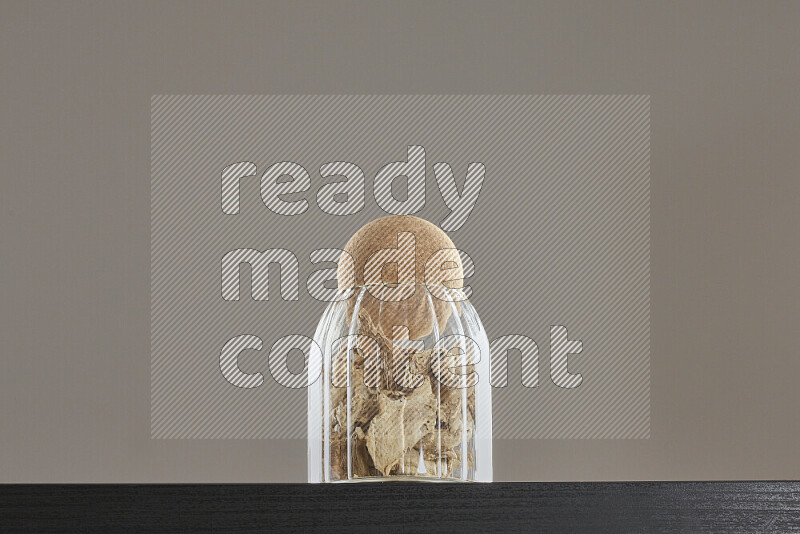 Dried ginger in a glass jar on black background