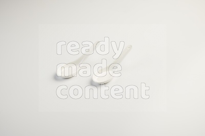 white ceramic soup spoon on white countertop