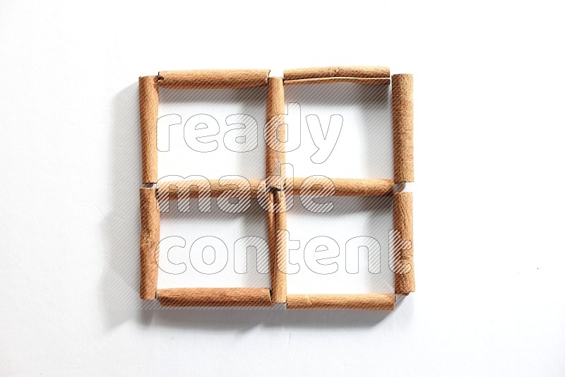 4 empty squares of cinnamon sticks on white flooring