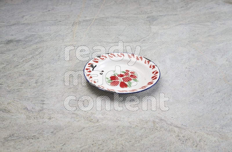 A Vintage Metal Plate On Grey Marble Flooring