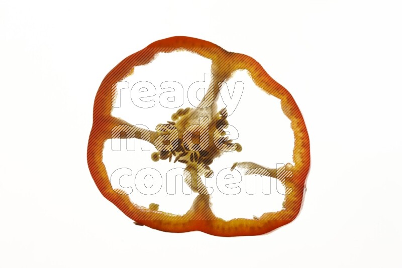 Red bell pepper slices on illuminated white background