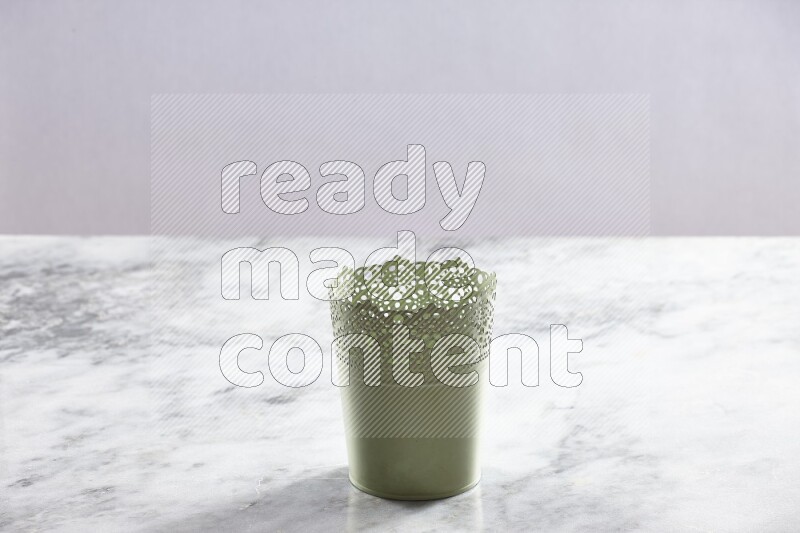An empty green plant pot on grey marble background