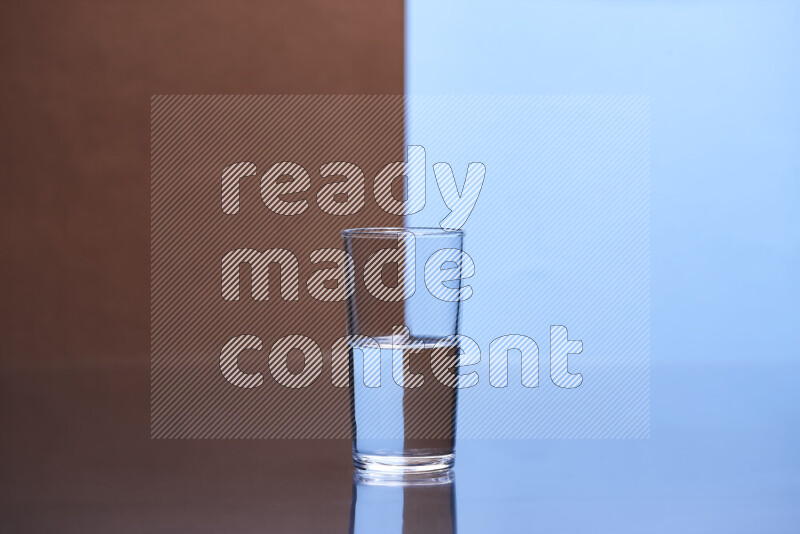 The image features a clear glassware filled with water, set against brown and light blue background