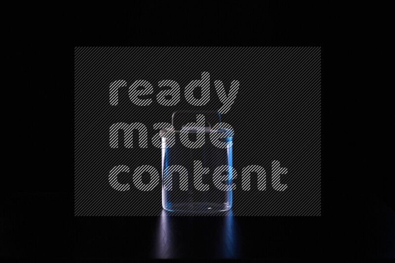 Glassware with rim light in blue and white against black background