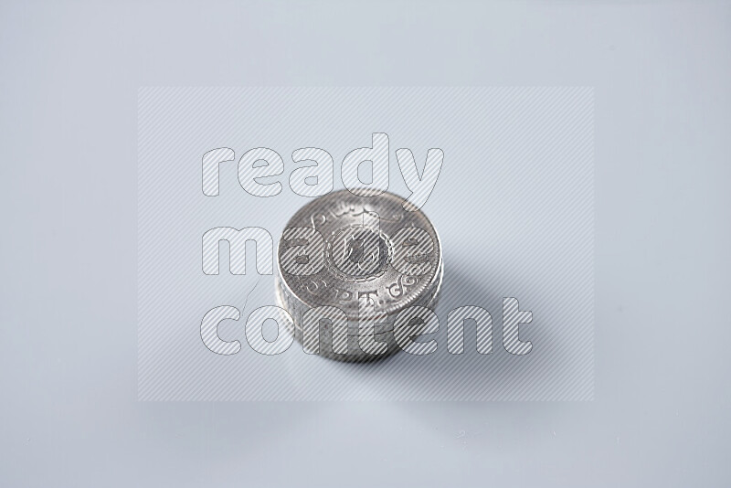 Stack Egyptian 25 piasters coins on grey background
