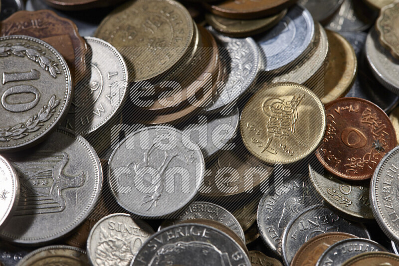 A close-ups of random old coins on black background