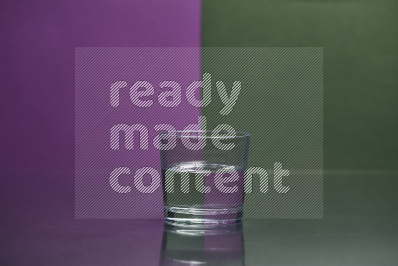 The image features a clear glassware filled with water, set against purple and dark green background