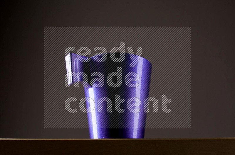 Low angle shot of a purple cup on grey background