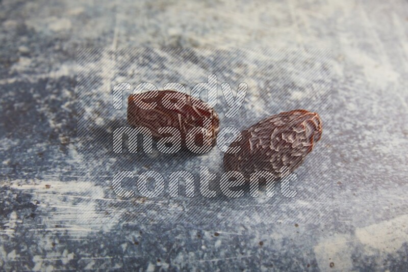 two madjoul dates on a rustic blue backround