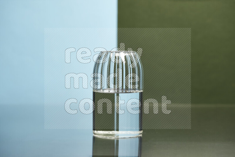 The image features a clear glassware filled with water, set against light blue and dark green background