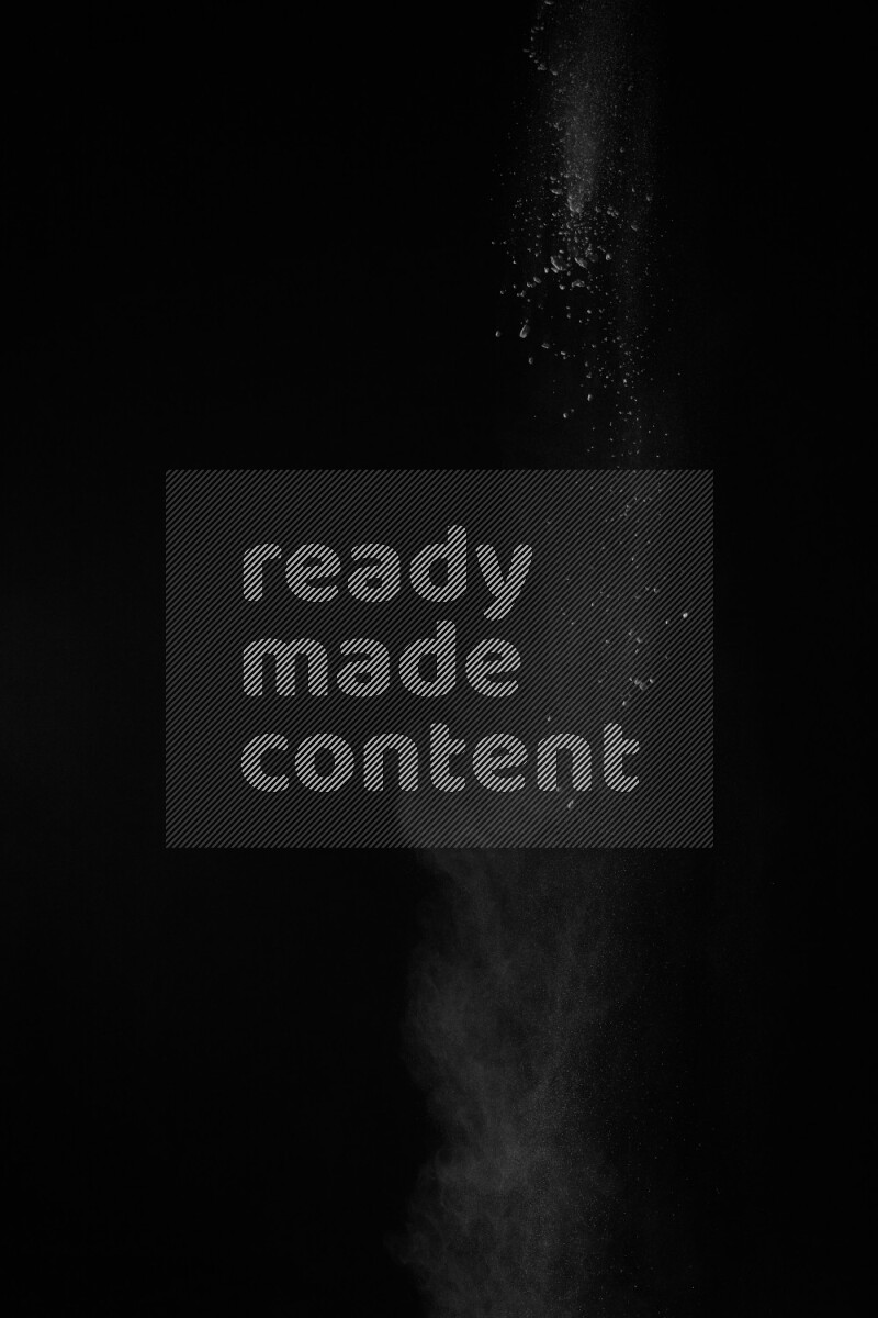 A side view of white powder explosion on black background
