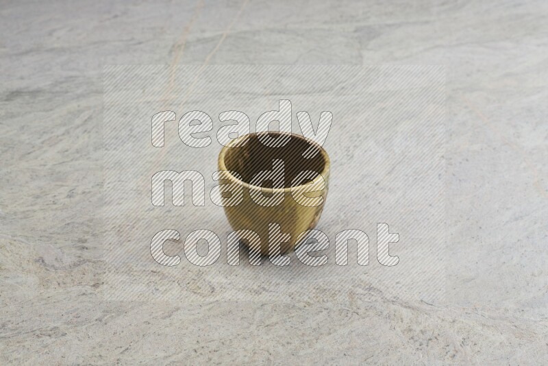 A multicolored pottery Cup on grey marble background
