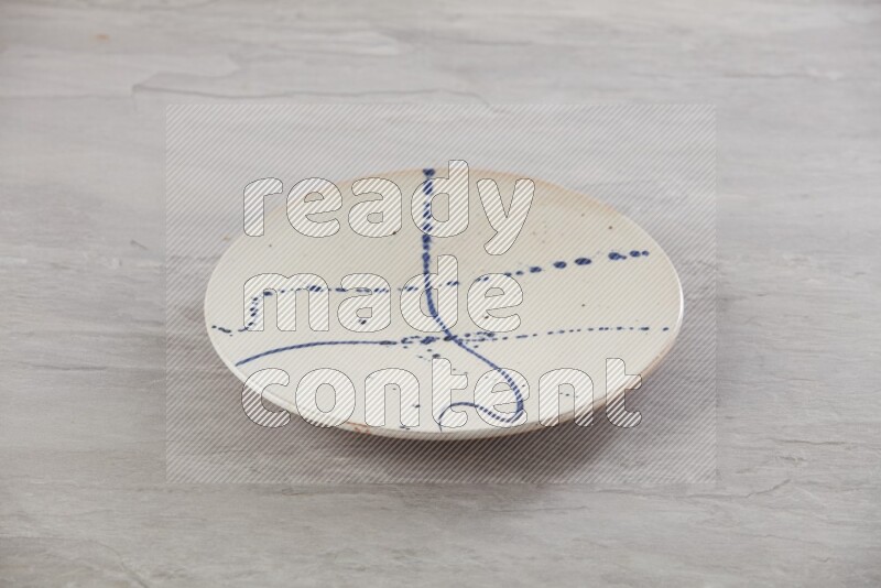 multi color ceramic round plate on grey textured countertop