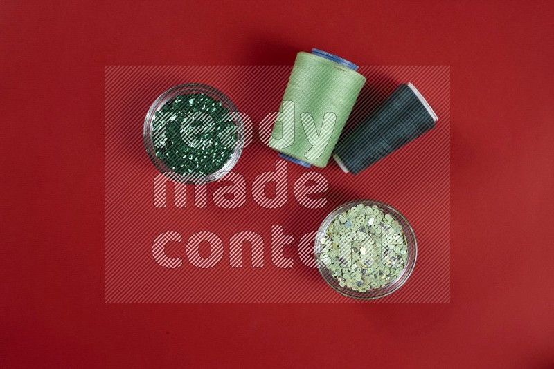 Green sewing supplies on red background