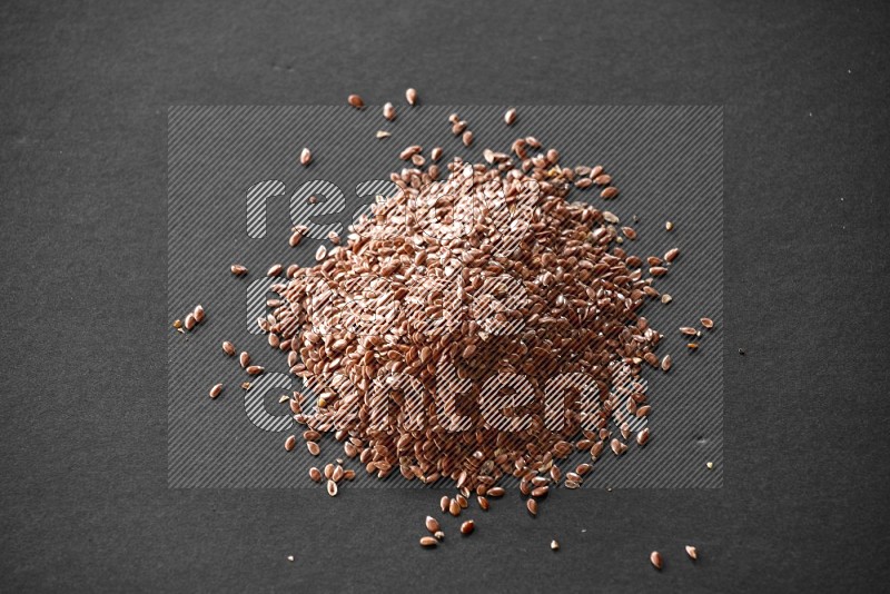 Flax seeds on a black flooring