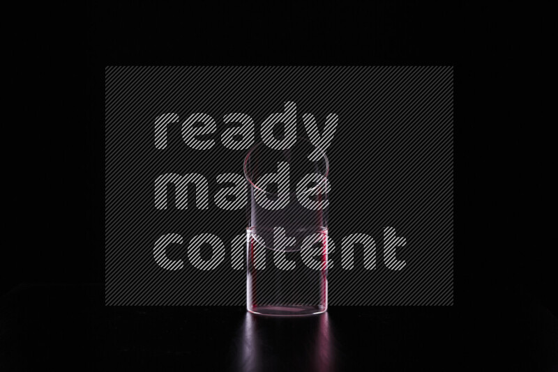 Glassware with rim light in red and white against black background