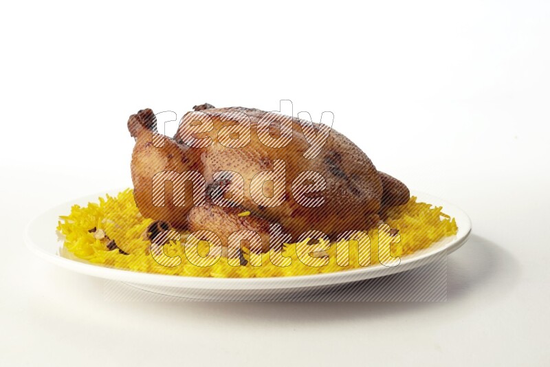 yellow  basmati Rice with  whole roasted chicken on a white rounded plate direct on white background