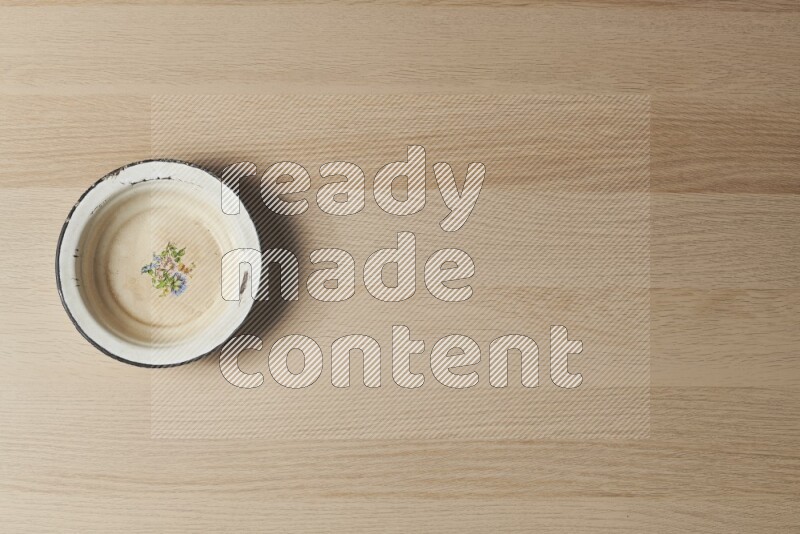 A vintage metal plate on light wooden background