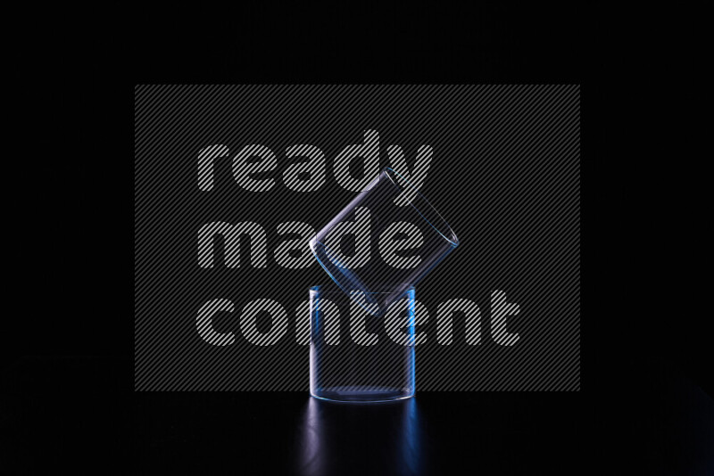 Glassware with rim light in blue and white against black background